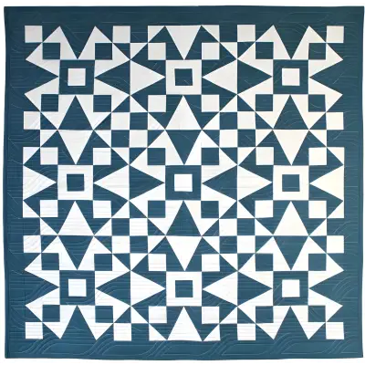 Geometric patterned quilt in teal blue and white from Art East Quilting Propeller Quilt Pattern