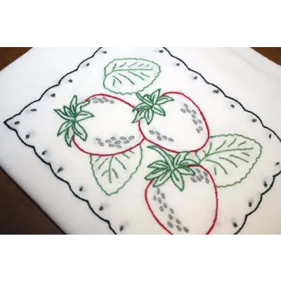 Embroidered strawberry design on Aunt Martha’s Fruit Tea Towels with scalloped border