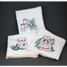 Set of embroidered white kitchen towels featuring floral and kitchenware designs from Aunt Martha’s