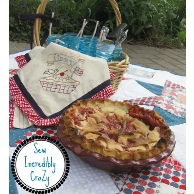 Aunt Martha’s #4022 pie showcases a lattice crust on a red checkered cloth, perfect for quilting