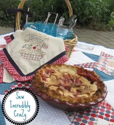 Aunt Martha’s #4022 pie showcases a lattice crust on a red checkered cloth, perfect for quilting
