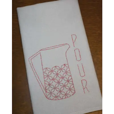 White tea towel with red pitcher design showcasing Sashiko Japanese embroidery by Aunt Martha’s