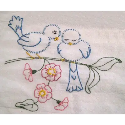 Hand-embroidered blue birds on a flowering branch from Aunt Martha’s Love in Bloom collection