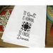 White tea towel with black text and quilting pattern from Aunt Martha’s Dirty Laundry